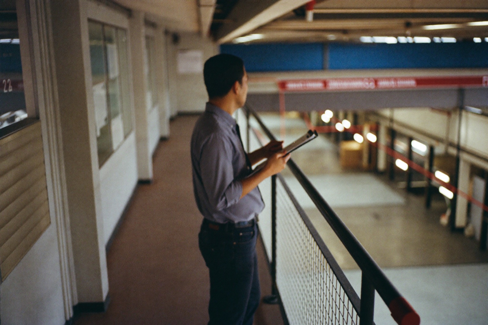 An operations manager looking out over a working floor